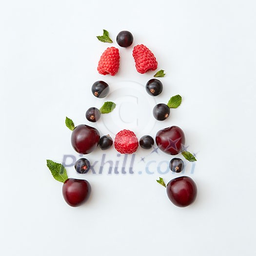 Letter A english alphabet in the form of a pattern of natural organic berries - ripe fresh raspberry, black currant, cherry, green mint leaf isolated on a white background. Flat lay