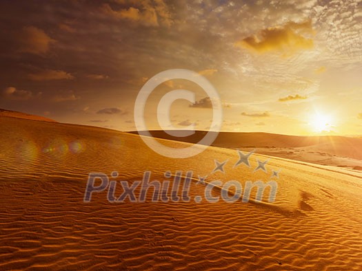 White sand dunes on sunrise, Mui Ne, Vietnam. With lens flare and light leak