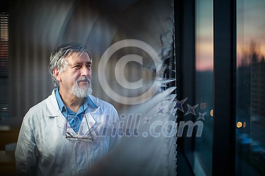 Senior chemistry professor by a classroom window, looking pensive (shallow DOF; color toned image)