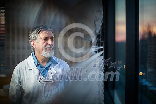Senior chemistry professor by a classroom window, looking pensive (shallow DOF; color toned image) Senior chemistry professor by a classroom window, looking pensive (shallow DOF; color toned image)