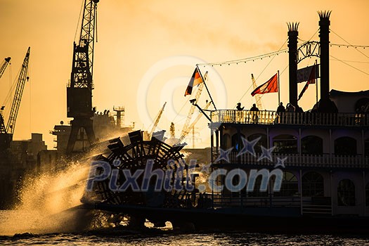Steam paddle boat in Hamburk, Germany, with a backdrop of a lovely sunset