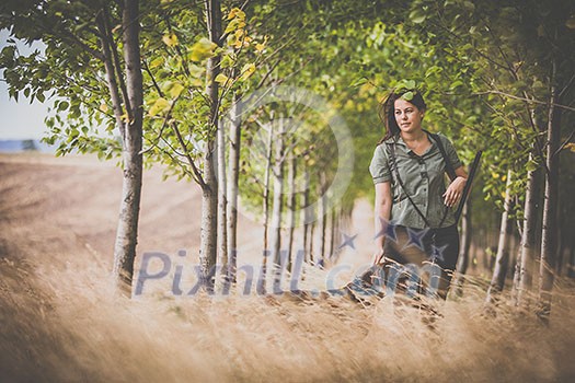 Autumn hunting season. Hunting. Outdoor sports. Woman hunter in the woods Autumn hunting season. Hunting. Outdoor sports. Woman hunter in the woods