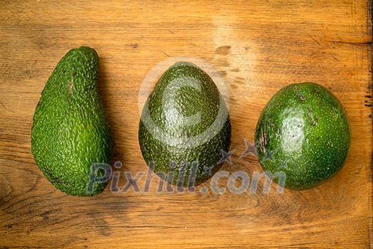 Avocados on a wooden kitchen table Avocados on a wooden kitchen table