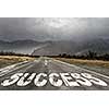 Conceptual image with word success on asphalt road