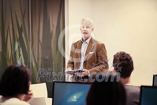 handsome mature teacher and students in computer lab classroom handsome mature teacher and students in computer lab classroom