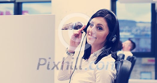 young smiling female call centre operator doing her job with a headset