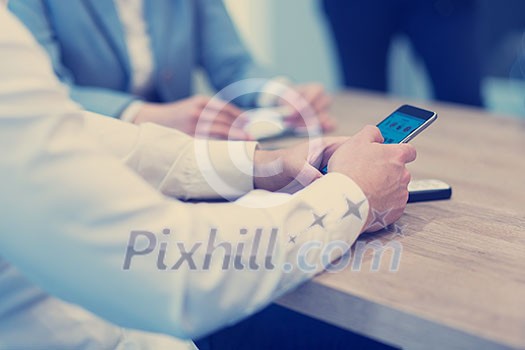 Young casual businessman using smartphone in the startup office Young casual businessman using smartphone in the startup office