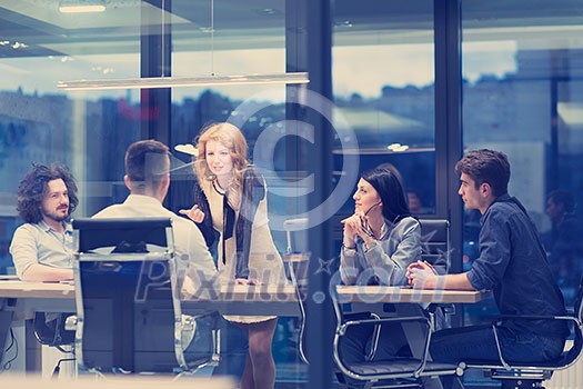Group of a young business people discussing business plan at modern startup office building Group of a young business people discussing business plan at modern startup office building