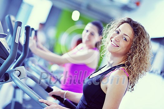 group of young people running on treadmills in modern sport  gym