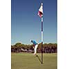 golf player hitting shot with driver on course at beautiful sunny day