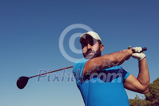 golf player hitting shot with club on course at beautiful morning with sun flare in background golf player hitting shot with club on course at beautiful morning with sun flare in background