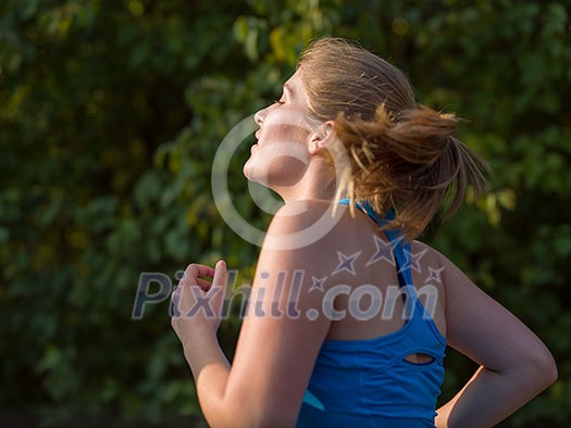 young woman enjoying in a healthy lifestyle while jogging along a country road, exercise and fitness concept young woman enjoying in a healthy lifestyle while jogging along a country road, exercise and fitness concept