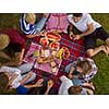 group of young friends enjoying picnic time drink and food in beautiful nature on the river bank top view