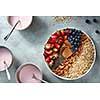 Useful ingredients for making breakfast from yoghurt in bowl, chia, berries and oatmeal on a plate on stone light background. Antioxidant, superfood, ideal for breakfast top view