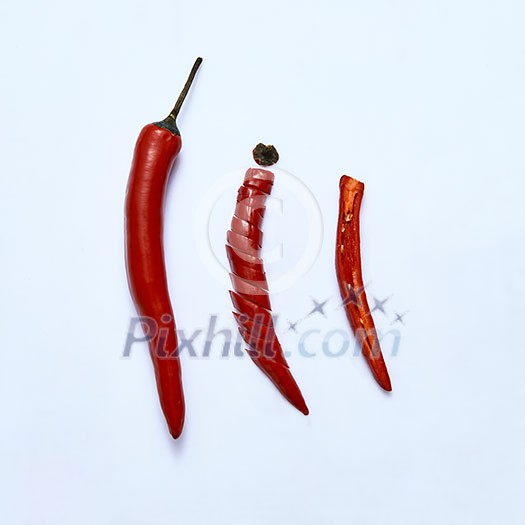 Red chili pepper cut into slices as a version of slicing for cooking on a gray background, top view Red chili pepper cut into slices as a version of slicing for cooking on a gray background, top view