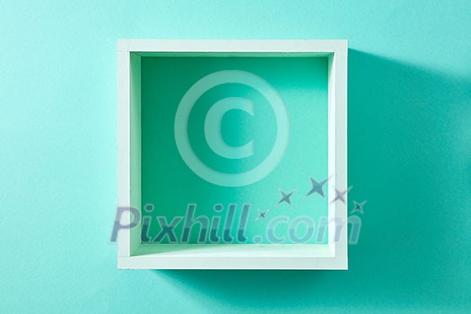Simple green wood box shelf in the form of a square isolated on a wall of mint color. Product display template