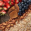 Close-up of a set of ingredients, oatmeal, granola, almonds, snacks, blueberries and strawberries halves top view. Healthy vitamin breakfast