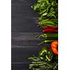 Food background - raw organic vegetables, fresh ingredients for healthily cooking on wooden background with copy space, flat lay. Vegetarian or healthy food