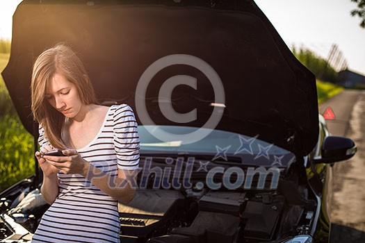 Pretty, young woman calling the roadside service/assistance after her car has broken down Pretty, young woman calling the roadside service/assistance after her car has broken down