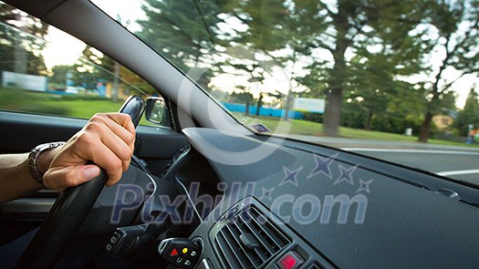 Man driving a car moving fast on a highway (motion blurred image) Man driving a car moving fast on a highway (motion blurred image)