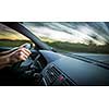 Man driving a car moving fast on a highway (motion blurred image)