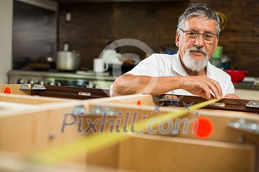 DIY concept - Senior man doing putting together kitchen cabinets DIY concept - Senior man doing putting together kitchen cabinets