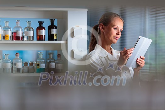 Portrait of a female researcher doing research in a biochemistry lab (shallow DOF; color toned image) Portrait of a female researcher doing research in a biochemistry lab (shallow DOF; color toned image)