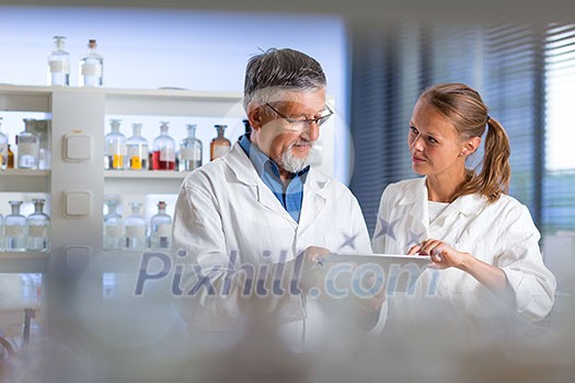 Senior chemistry professor/doctor in a lab (color toned image) Senior chemistry professor/doctor in a lab (color toned image)