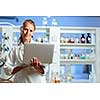 Portrait of a female researcher doing research in a lab (shallow DOF; color toned image)