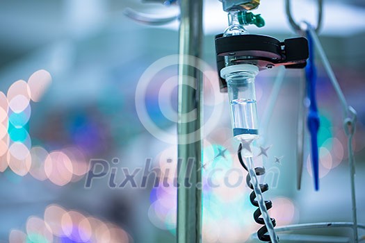 Drip irrigation equipment in hospital surgery room by the operations table, conceptual image - lovely blurred background Drip irrigation equipment in hospital surgery room by the operations table, conceptual image - lovely blurred background