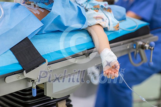 Unidentified child patient undergoing a surgery (no faces, shallow DOF)