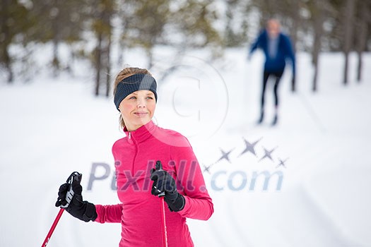 Cross-country skiing: young woman cross-country skiing on a winter day
