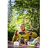 Female hiker/climber preparing supper on gas burner in a camp