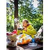 Female hiker/climber preparing supper on gas burner in a camp