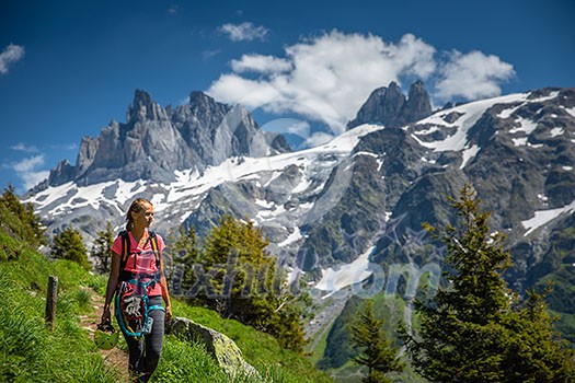 Pretty, female hiker/climber in a lovely alpine setting of Swiss Alps