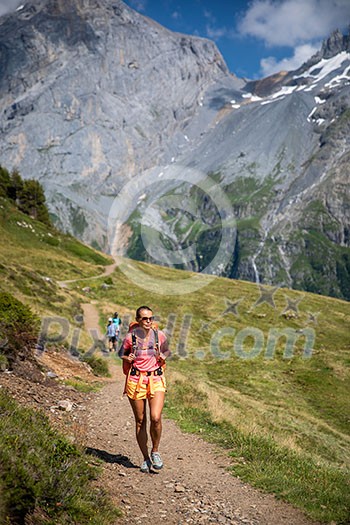 Pretty, female hiker/climber in a lovely alpine setting of Swiss Alps
