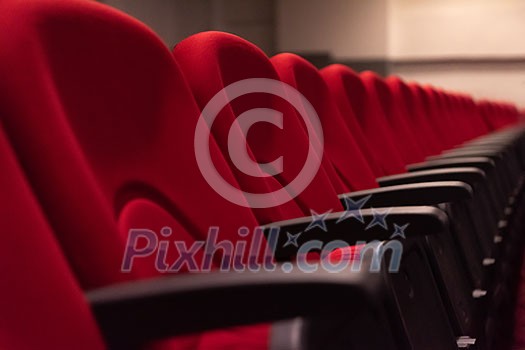empty conference,theater or cinema hall with rows of red seats