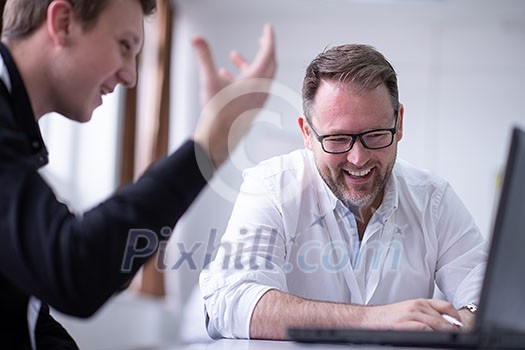 Group of a young business people brainstorming and discussing business plan on meeting at startup office interior Group of a young business people brainstorming and discussing business plan on meeting at startup office interior