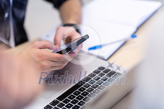business people hands typing on smart phone during the seminar at conference room