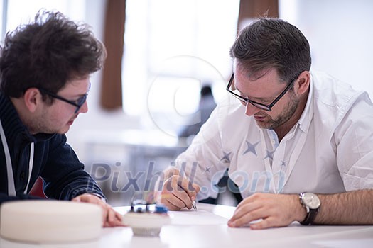 Group of a young business people brainstorming and discussing business plan on meeting at startup office interior Group of a young business people brainstorming and discussing business plan on meeting at startup office interior