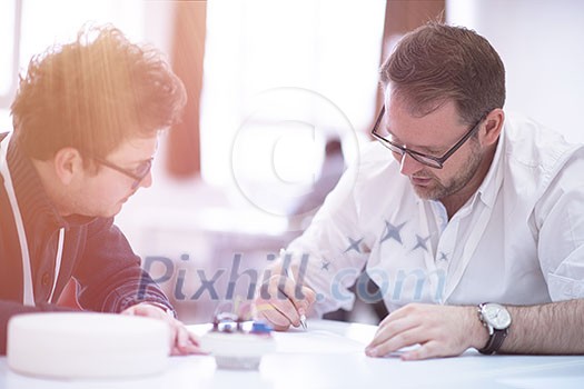 Group of a young business people brainstorming and discussing business plan on meeting at startup office interior Group of a young business people brainstorming and discussing business plan on meeting at startup office interior