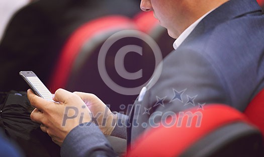 business people hands typing on smart phone during the seminar at conference room business people hands typing on smart phone during the seminar at conference room