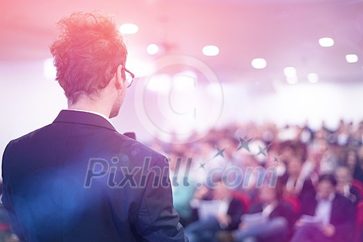 young businessman at business conference room with public giving presentations. Audience at the conference hall. Entrepreneurship club