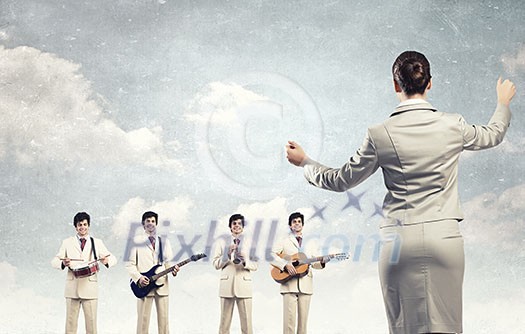 Man orchestra playing different music instruments and woman leader Man orchestra playing different music instruments and woman leader