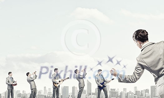 Man orchestra playing different music instruments and woman leader Man orchestra playing different music instruments and woman leader
