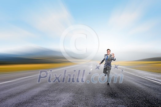 Young businessman in suit running on asphalt road Young businessman in suit running on asphalt road