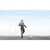 Young businessman in suit running on asphalt road