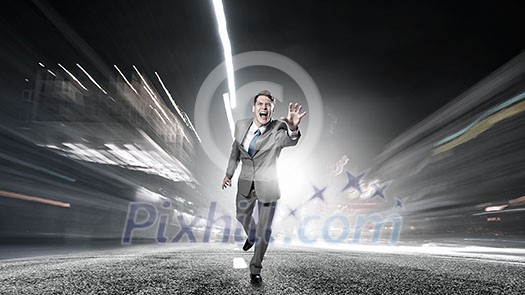 Young businessman in suit running on asphalt road Young businessman in suit running on asphalt road
