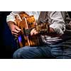 Man playing a guitar on stage (shallow DOF; color toned image)