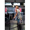 Young woman with her luggage at an international airport, before going through the check-in and the security check before her flight